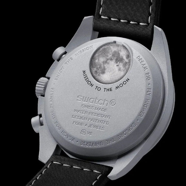 Swatch watch with moon phase display on a black background